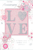 This romantic anniversary card mirrors the feeling of receiving a hand-delivered bouquet in Harold Hill, captured in a palette of soft pastels and shimmering accents. At its heart, the word LOVE appears in softly cushioned, raised letters, their surfaces coated with a fine dusting of glitter that sparkles in blush pink, pearlescent white, and hints of silver. The letters rest against a gentle, powder-pink background that seems to glow quietly, adding warmth and tenderness to the design. Encircling this central word, clusters of stylised blossoms and curling vines stretch gracefully across the card, resembling the early sketch of a florist planning a romantic anniversary display. The flowers are drawn with slender, refined lines and shaded with delicate tones of blush, mauve, and cool grey, blending to create an almost watercolour effect while retaining crisp, elegant shapes. Tiny petals, swirling flourishes, and subtle butterfly motifs weave among the blooms, bringing a sense of lightness and motion, like petals carried on a breeze through Harold Hill's residential gardens. The phrases On Our Anniversary and I love you today and always are written in a refined, flowing script, their curves mirroring the shapes of the vines and stems. Every element-the textures, colours, and placement-feels intentional, as though guided by the practiced eye of a local florist designing for a cherished milestone. The result is a card that feels both delicate and deeply heartfelt, a paper tribute to enduring love shared in Harold Hill.